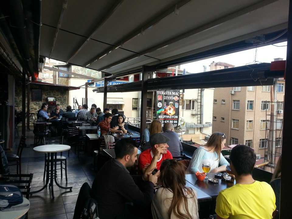 People in a bar taking and enjoying the evening